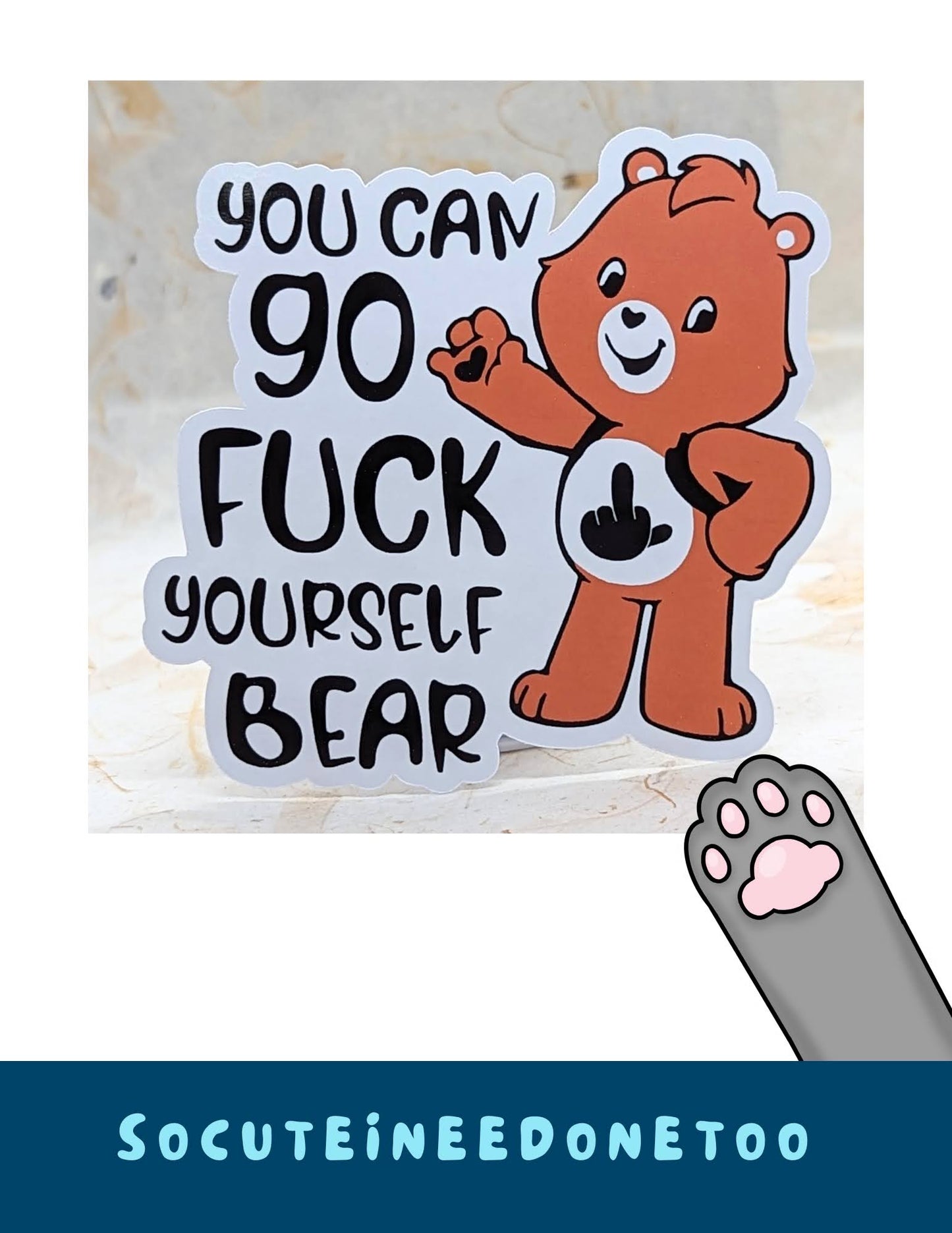 A sticker with a Care Bear character with a text 'Annoying Ray of Fucking Sunshine Bear' on a beige background.