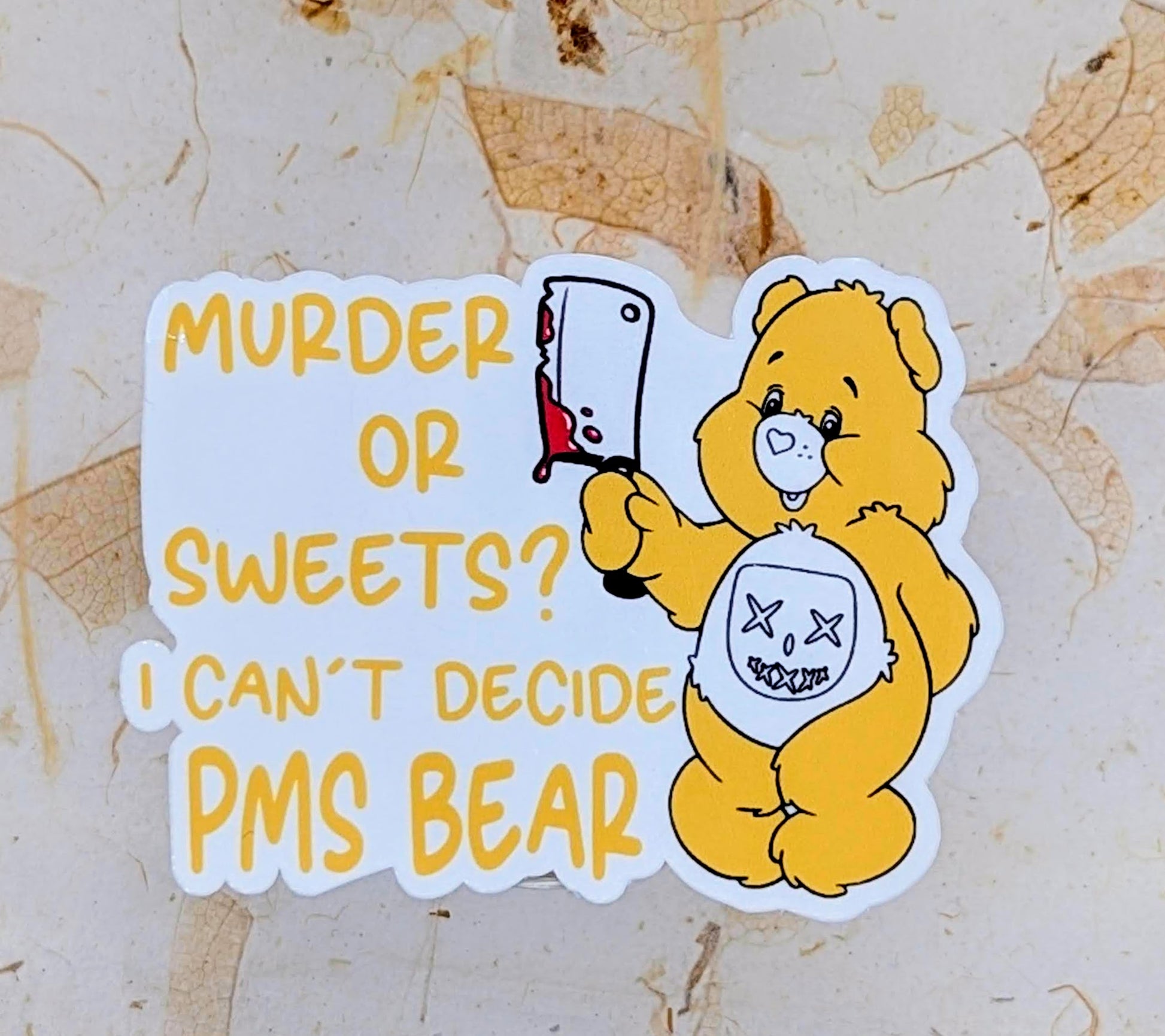 A sticker with a Care Bear character with a text 'Annoying Ray of Fucking Sunshine Bear' on a beige background.