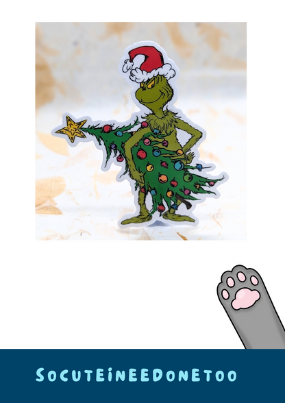 Grinch with a Christmas tree and Santa hat 