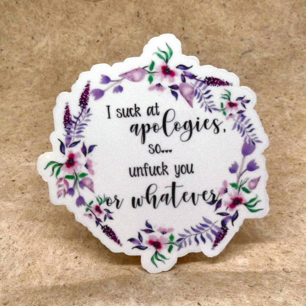 I Suck At Apologies floral wreath die-cut vinyl sticker, real product photo