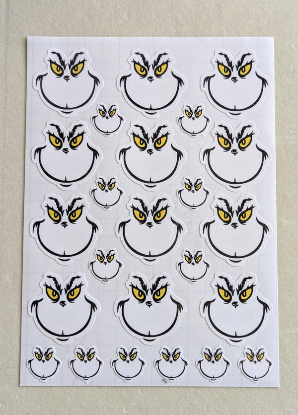 Sheet of grumpy Christmas face stickers in two sizes