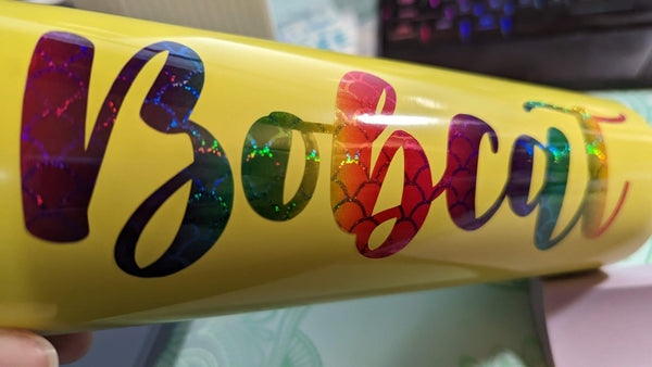 Rainbow holographic script name vinyl decal on a yellow tumbler