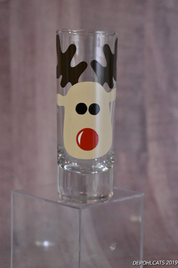 Red-nosed reindeer vinyl decal on a shot glass