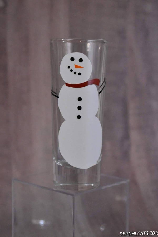 Classic snowman vinyl decal on a shot glass