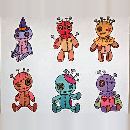 Close-up of six voodoo doll stickers including witch hat doll, real product photo