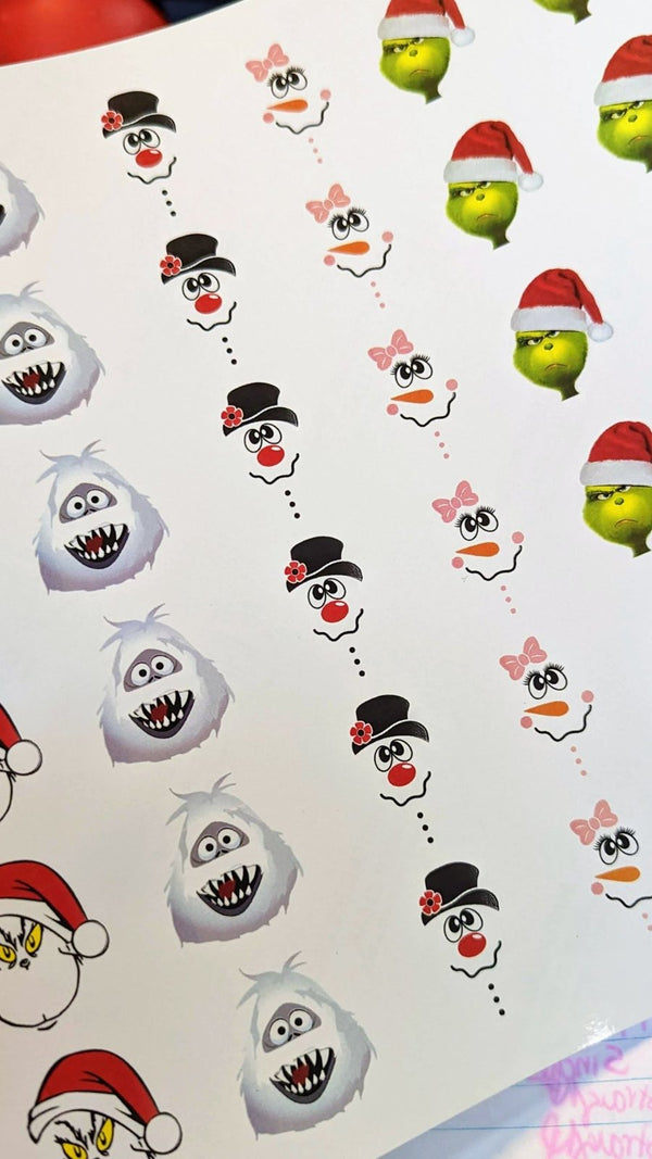 Christmas character face waterslide decals: snowmen, yeti and grumpy green faces in Santa hats