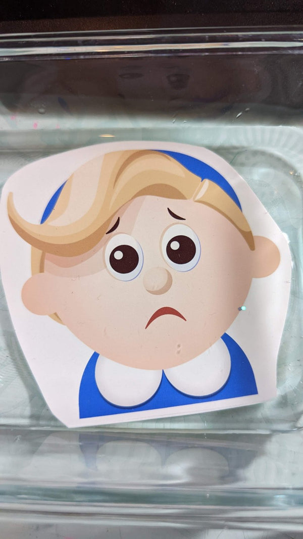 Sad little elf face Christmas peeker waterslide decal floating in water