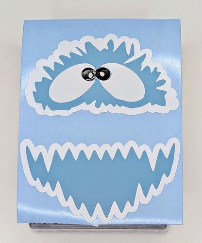 Yeti face vinyl decal in light blue, white and black on transfer backing